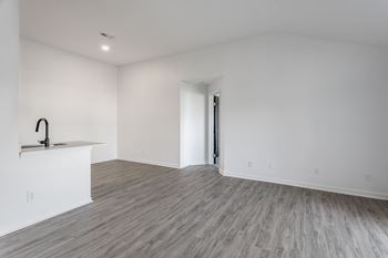 A room with a wooden floor and a sink